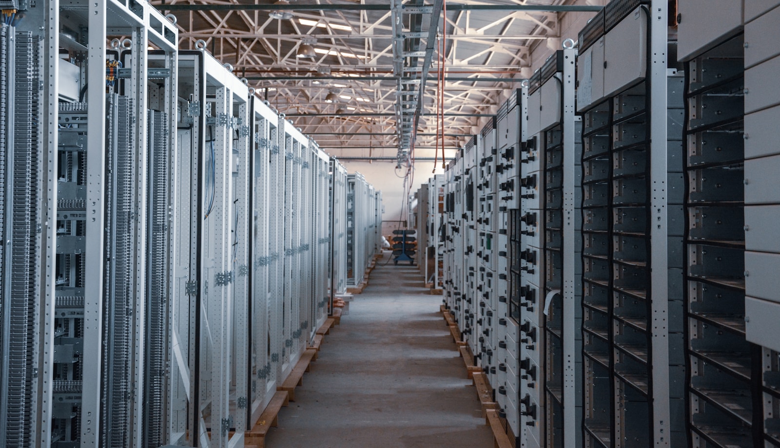 Rows of electrical and server equipment in an industrial hall